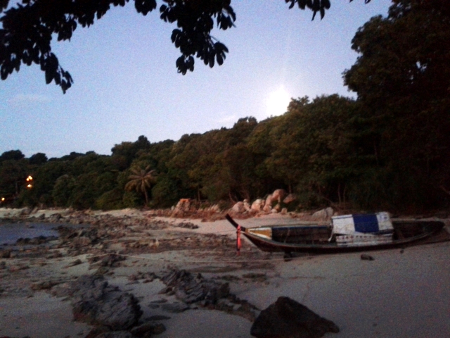 A deserted part of the sunset beach. The bright light in the backround is a full moon.